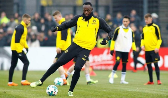 Usain Bolt with his new Australian football club: takes one week leave from soccer