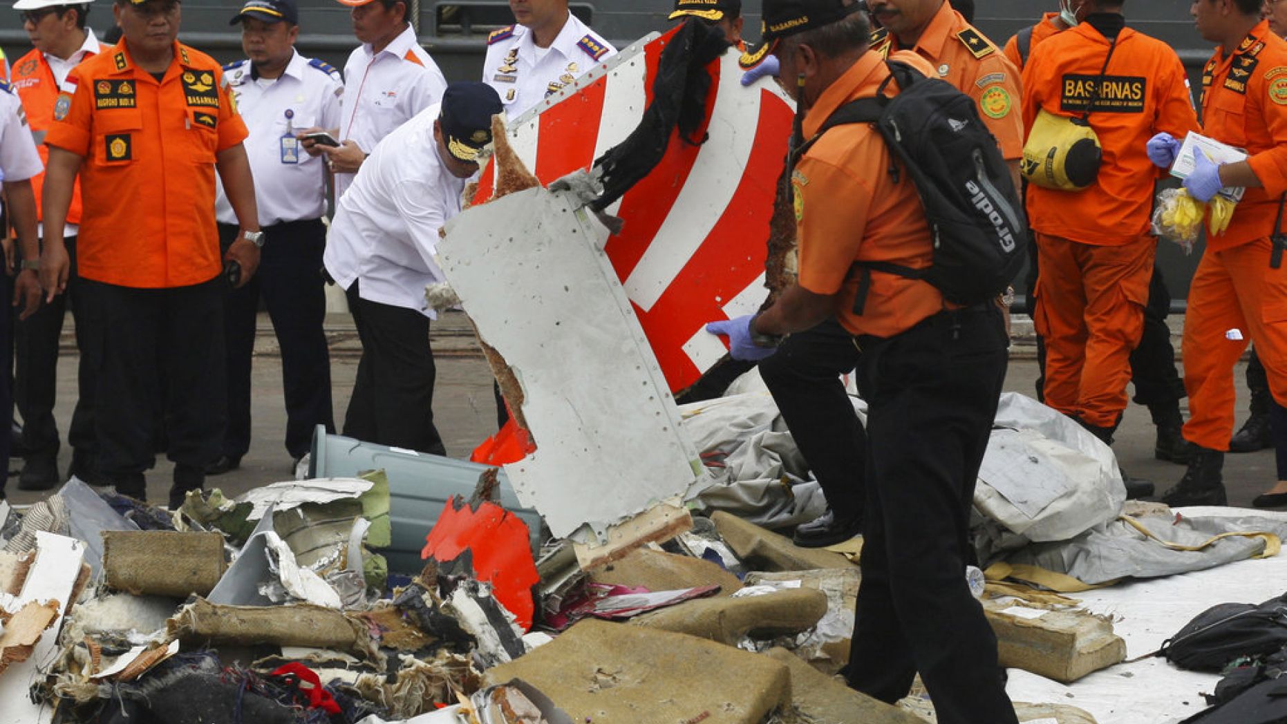 Rescuers inspect part of Lion Air plane flight JT 610 retrieved from the waters where it’s believed to have crashed at Tanjung Priok Port in Jakarta, Indonesia