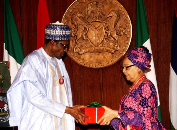 President Buhari receives the Tripartite Committee report on new national minimum page from Ms Ama Pepple