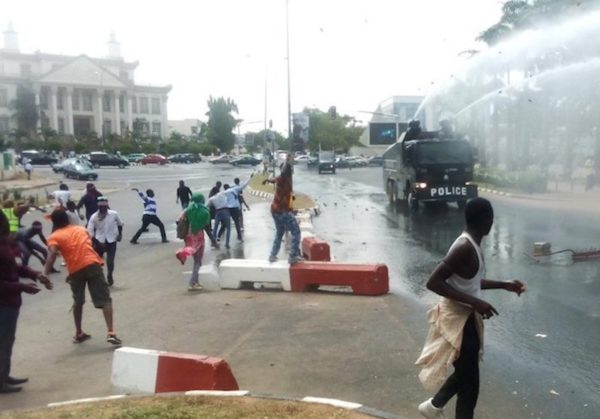 Stone-throwing Shi’ites confront anti-riot police vehicle in Abuja on 30 October. Police, DHQ flay Amnesty International report