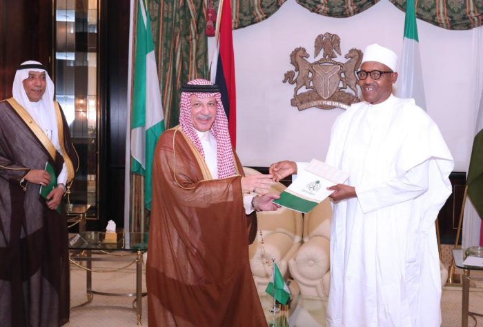 President Buhari receiving a message from King Salman of Saudi Arabia